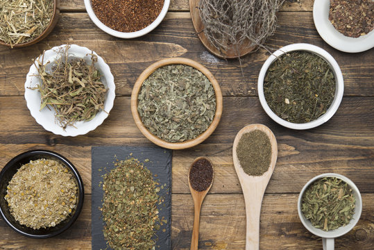 Various herbal infusions on wood, chamomile, mint, rooibos, thyme, green tea, tisane