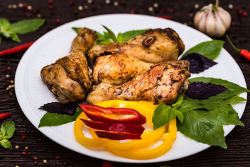 Roasted chicken quarter legs on rustic background