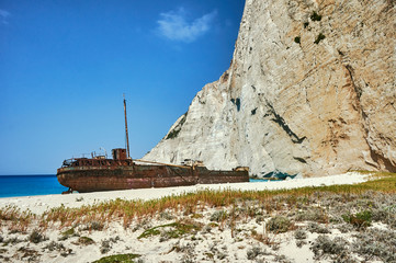 A rusty shipwreck on a rocky beach on Zakynthos Island