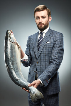 A man in a business suit with fresh salmon