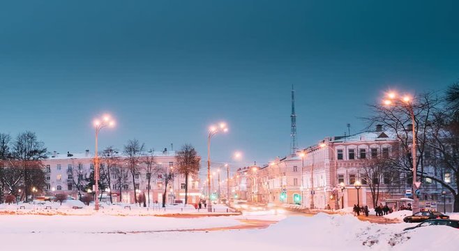 Gomel, Belarus. Time Lapse Time-lapse From Day To Night. Traffic And Light Trails Near Building Of Gomel Regional Drama Theatre On The Lenin Square In Winter Season. Change Of Day To Night