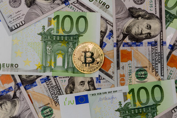 Fototapeta na wymiar Gold Bitcoin coin on Euro and Dollars banknotes background