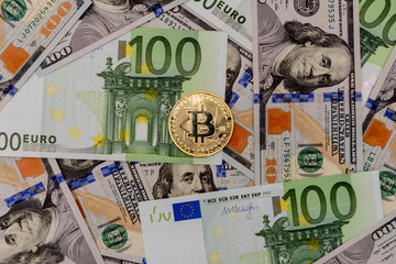 Fototapeta na wymiar Gold Bitcoin coin on Euro and Dollars banknotes background