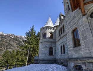 Fototapeta na wymiar Gressoney-Saint-Jean, Valle d'Aosta region, Italy. 25 April 2018. Castel Savoia, is a villa built in the late 1800s in eclectic style. In a fairytale context, photos of the exterior. Sunny day.