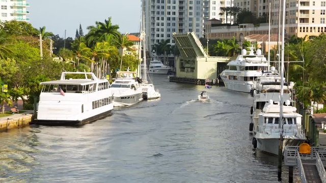 Boat passing rised drawbridge in Fort Lauderdale, Florida. RAW cideo source