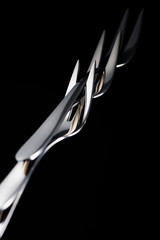 stainless forks with two tines isolated on black