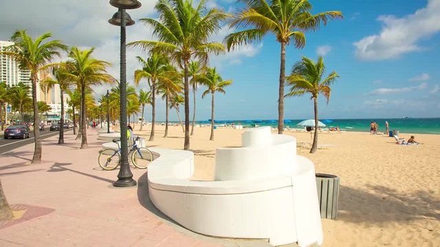 People having a rest on the Fort Lauderdale beach and walking on seafront. RAW video source.