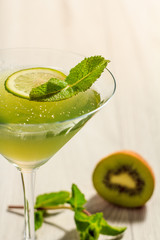 Kiwi jelly with lime piece in the glass topped mint leaves