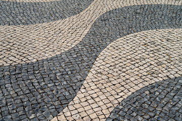 Typical portuguese cobblestone pavement pattern . black and white