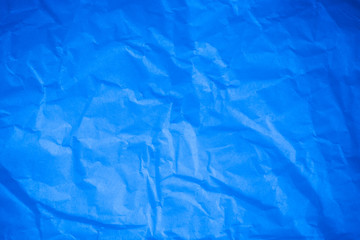 Obraz premium Crumpled blue paper background.