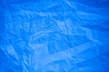 Crumpled blue paper background.