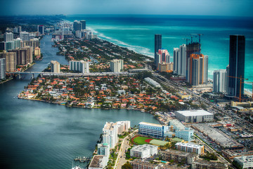 Fototapeta na wymiar MIAMI BEACH - MARCH 29, 2018: Aerial view of Miami Beach skyline with buildings. The city attracts 20 million people annually