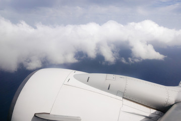 Fototapeta na wymiar View from plane window on engine and clouds.