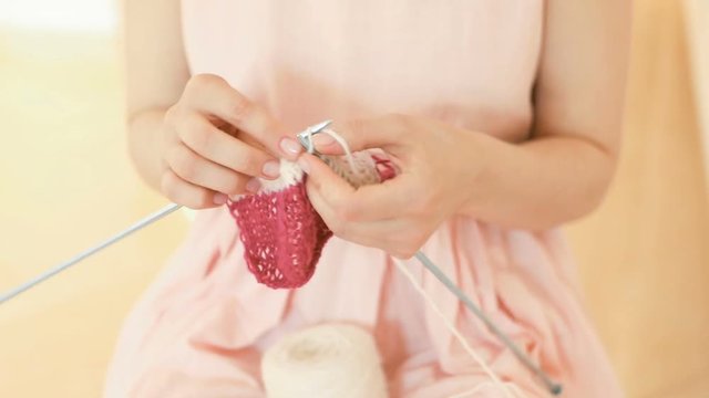 knitting hand made hobby. Young woman hands with coll hipster tattoo working. Crochet knitting. Soft daylight. Video footage. DSLR camera