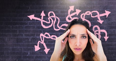 Stressed confused woman with pink arrow squiggly doodles on wall