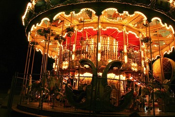 Night fun in Paris street, merry-go-round in the lights attracting tourists with fantasy
