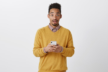 Guy received unbelievable message with offer. Good-looking surprised american guy with curly...