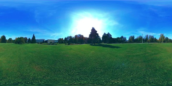 UHD 4K 360 VR Virtual Reality of a city park recreation area. Trees and green grass at autumn or summer day. Path and sun rays. Original sound.