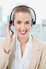 Smiling pretty call centre agent wearing headset 