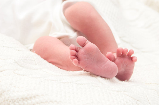 Little legs of a newborn baby