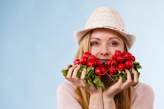 Happy woman holding radish