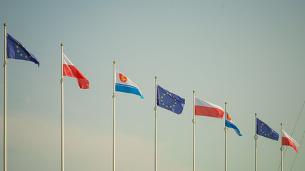 Flags of Poland, European Union city Gdynia against sky