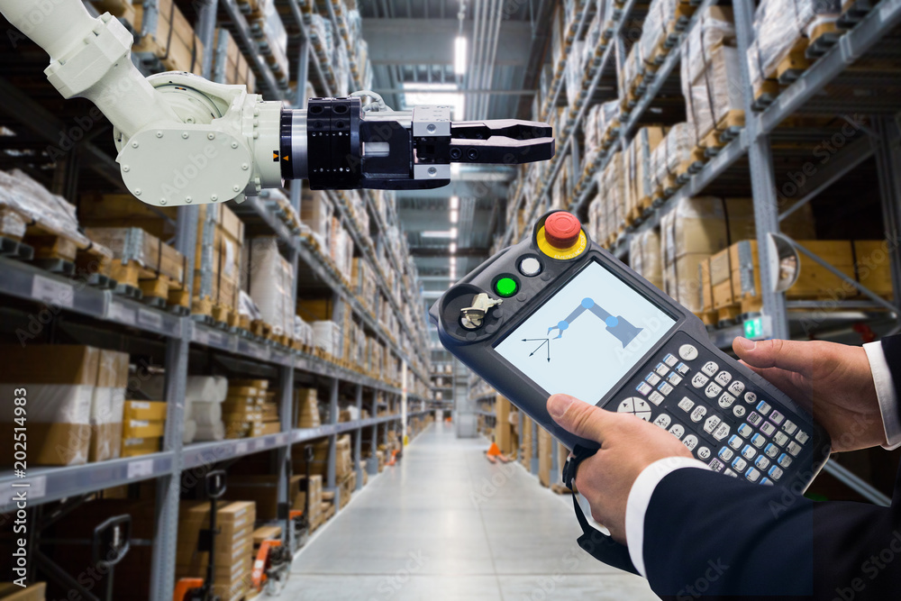 Aufkleber Engineer with teach pendant device. Programming robot with robotic arm in warehouse
