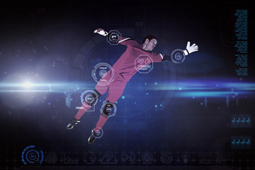 Fit goal keeper jumping up against blue dots on black background