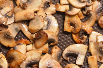 Beautiful fried mushrooms in a frying pan with non-stick coating