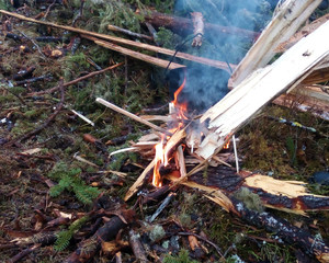 Bonfire on a halt in the campaign, boiling water for tea, laying firewood in a fire