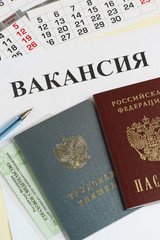 Russian documents for employment: employment record book, passport and insurance certificate. The inscription in Russian Vacancy