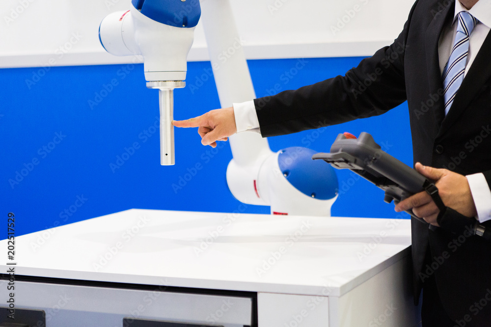 Aufkleber The engineer demonstrates the work of the robot-collaborator
