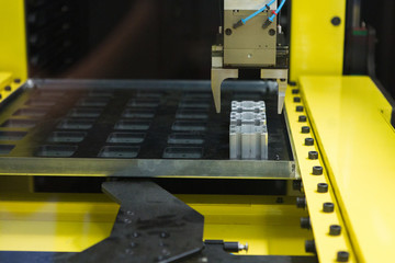 Automatic machine with robotic arm in a modern automated factory