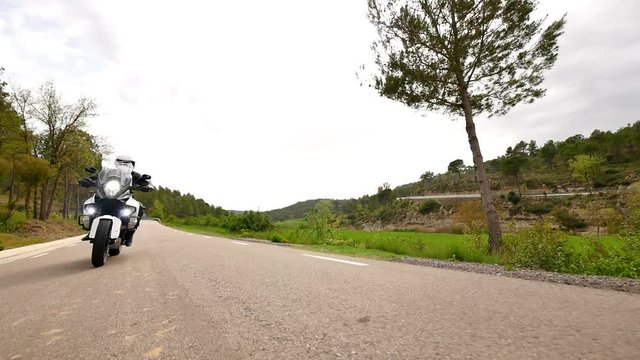 Motorcyclist Driving his Sports Motorbike on a Curvy Road.
Steady cam shot of a young man with his motorbike in spring.
Low angle wheel view of a cross motorcycle in action on a scenic road.