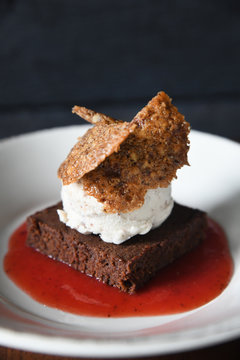 Brownie dessert with ice cream and strawberry sauce