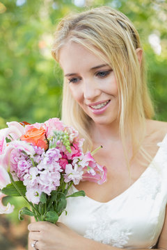 Excited bride looking at her bouquet