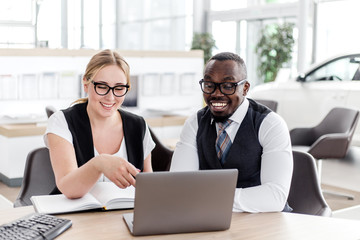 Fototapeta na wymiar Business woman working in office with the African man