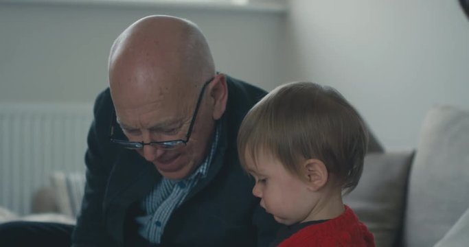 Grandfather with his grandson at home