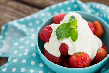 Close-up of fresh strawberries with cream in bowl