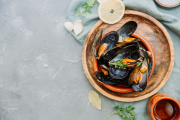 Steamed mussels in white wine sauce. Top view, copy space