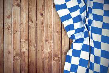 Blue and white flag against wooden planks