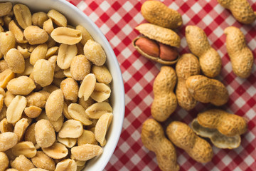 Peanuts. Food of Festa Junina, a typical brazilian party. Snack on plate, red plaid table.