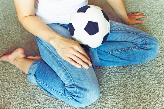 A Woman In Blue Jeans With A Soccer Football Ball