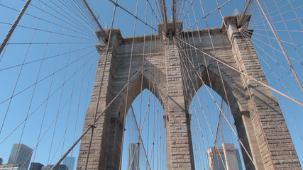 CLOSE UP: Structure of stunning Brooklyn bridge with city downtown in background