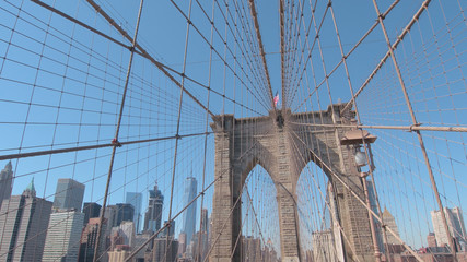 CLOSE UP: Iconic Brooklyn Bridge overlooking New York downtown business district