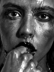 Black and white photos of an emotional girl in the shower. Drops flow down the face. The ink flowed. She looks crazy. Teeth. Smile. View. - 202536502