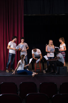 Actors Reading Their Scripts On Stage