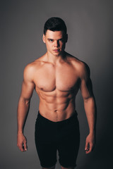 Fototapeta na wymiar Strong stylish successful man. Men's look. Color brutal man portrait. Brutal man with a sporty and inflated body. Strong athletic guy with bare chest.