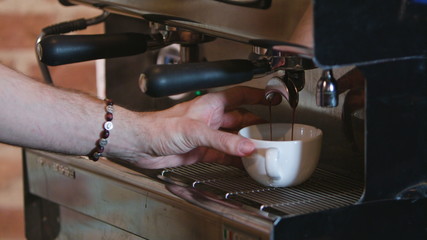 Close-up of espresso pouring from coffee machine. Professional coffee brewing
