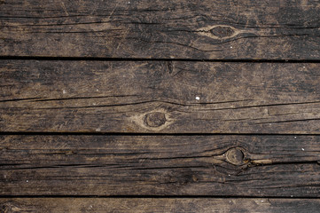 Macrophotography texture background of old dark wooden boards horizontally arranged in a wall
